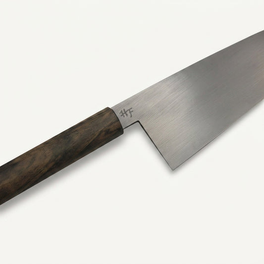 Close-up of the HandFab MK-III chef knife blade showing the 80CRV2 carbon steel heel and HF maker's mark