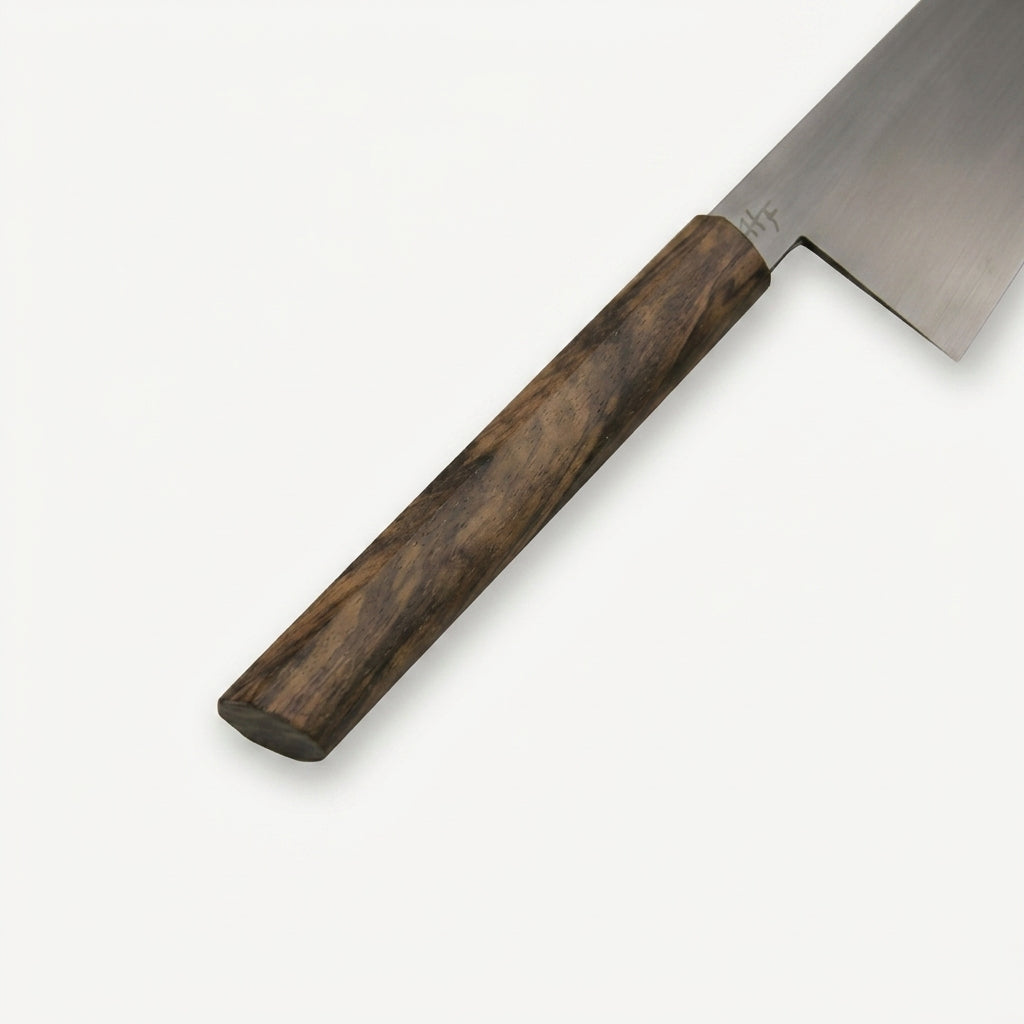 Detail of the HandFab MK-III walnut handle showing the faceted top edge and rounded butt end
