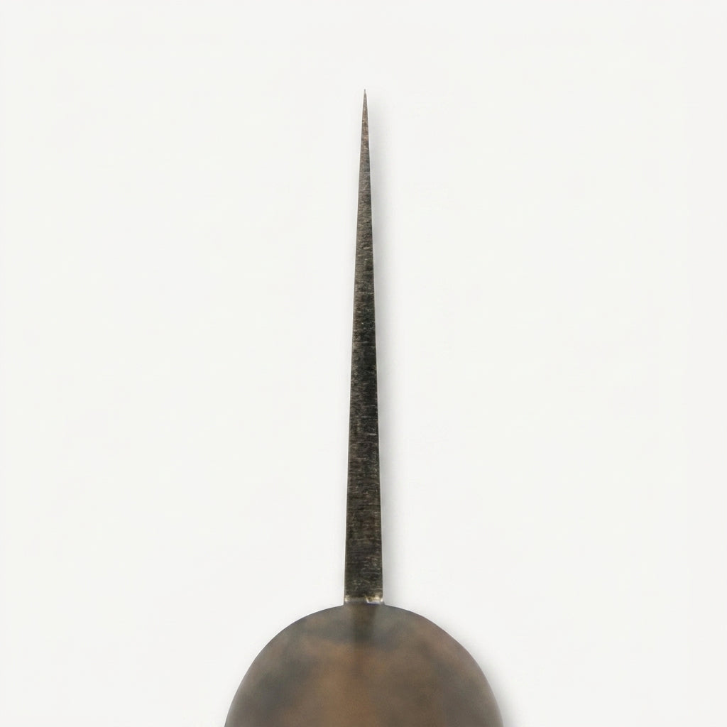 Close-up of the HandFab MK-III chef knife tip showing the extreme fine point and forged spine